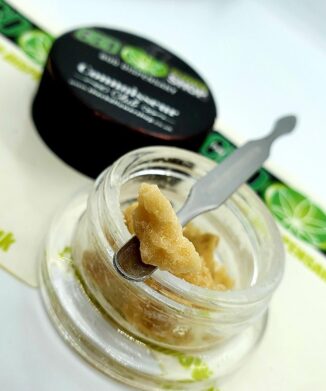 Image of CBD wax crumble in small clear pot