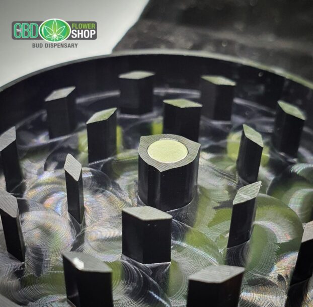 The CBD Flower Shop black metal tea grinder inside