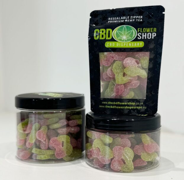 Two pots and a bag of cherry cbd gummies