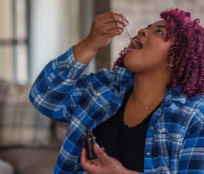 Woman consuming CBD oil
