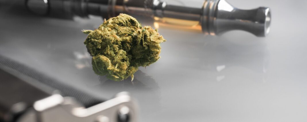 A CBD tea flower and vape pen with CBD oil in the cartridge