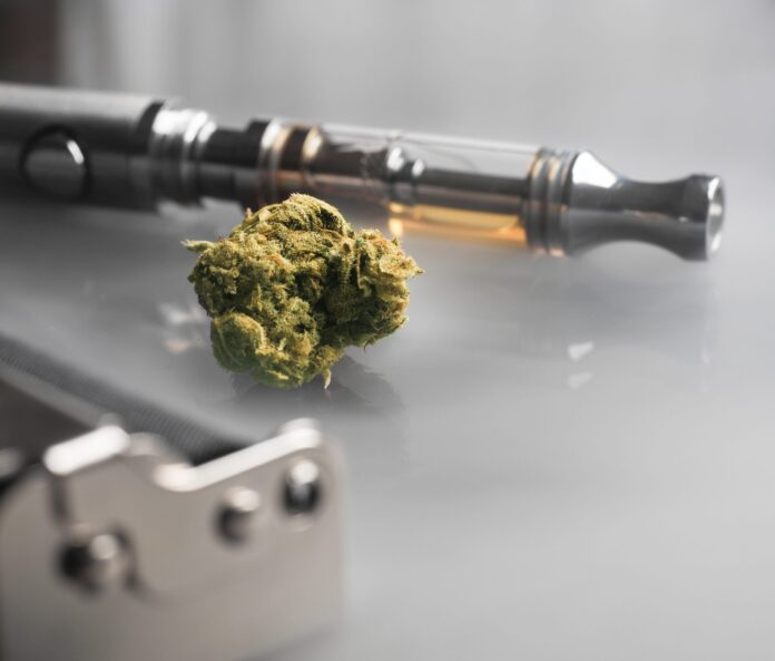 A CBD tea flower and vape pen with CBD oil in the cartridge