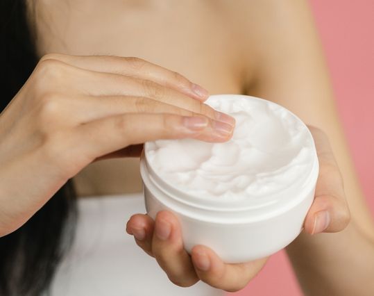 woman applying cbd balm