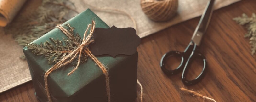 Present wrapped in green paper with a jute bow