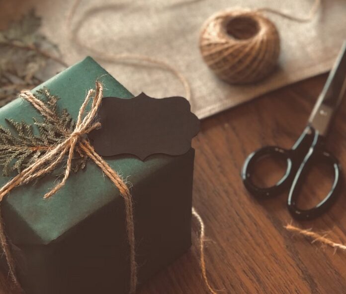Present wrapped in green paper with a jute bow