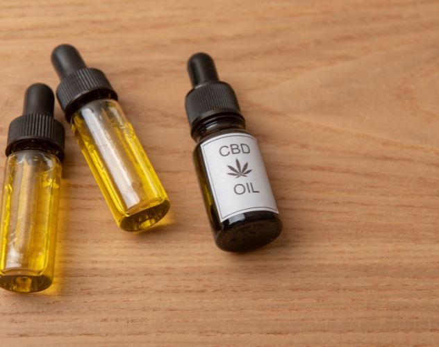 CBD oil bottles on wooden surface