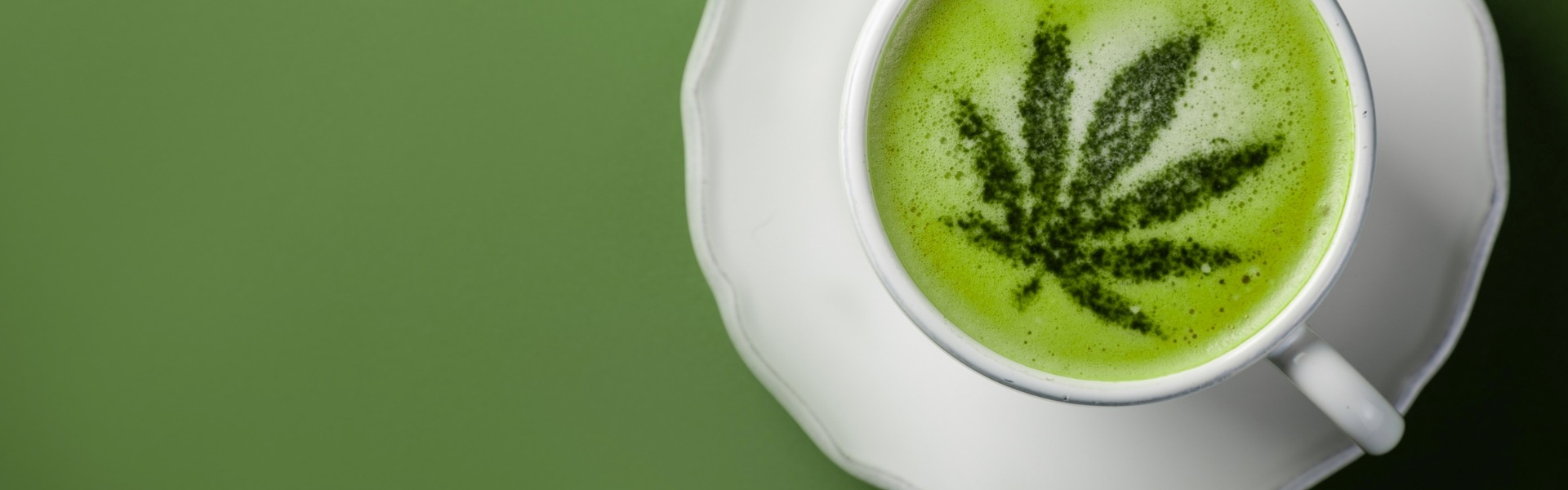 Green Hemp Leaf design over milk in a cup