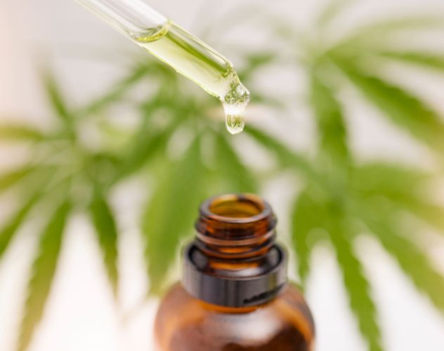 open bottle of cbd oil with oil dropper