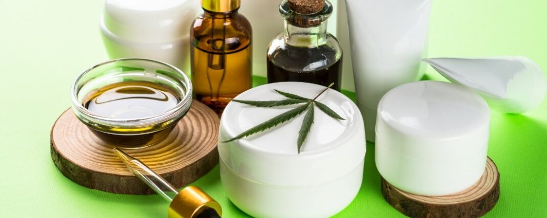 Range of CBD skincare products on green background