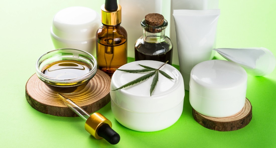 Range of CBD skincare products on green background
