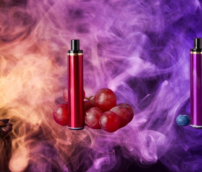 flavoured vapes in front of a purple and blue smoke