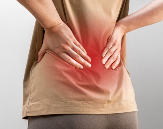 person holding back highlighted in red demonstrating pain area
