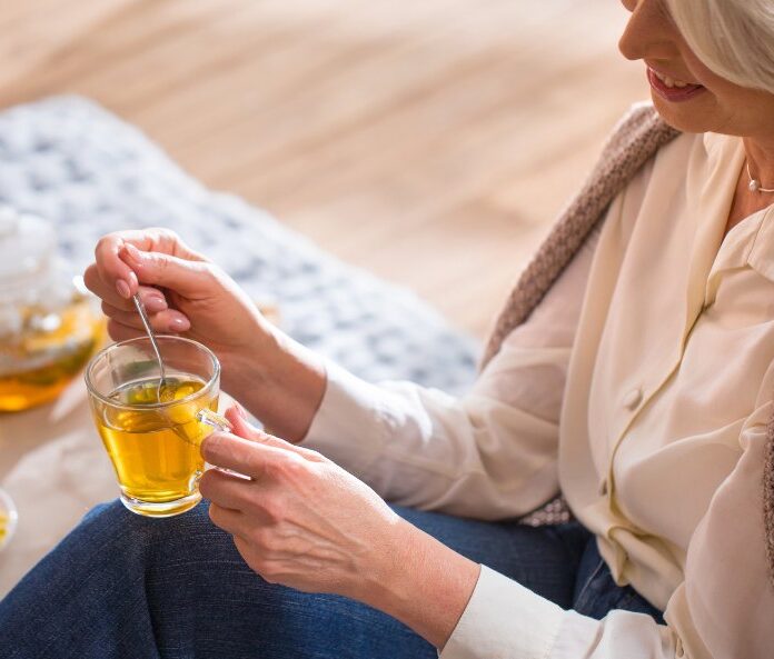 a woman enjoying cbd tea
