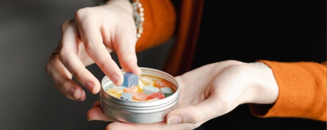 woman taking CBD gummies for pain relief