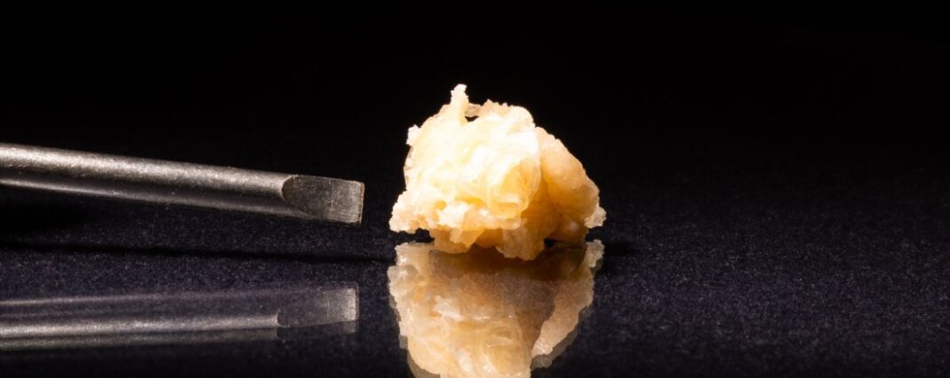 cbd concentrate on black background with reflection