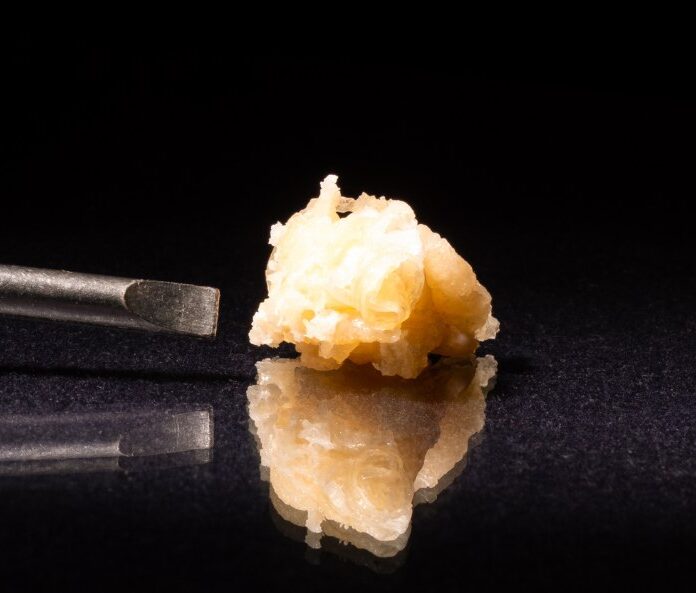 cbd concentrate on black background with reflection