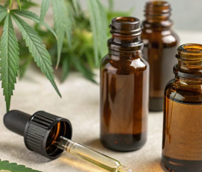 cbd oil bottles with hemp plants in the background