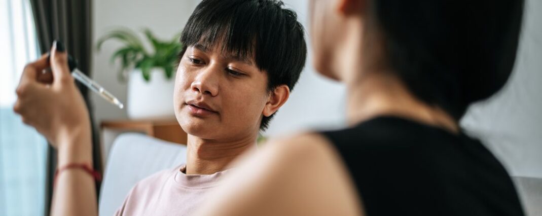 Woman giving man cbd oil