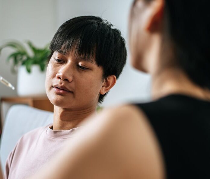 Woman giving man cbd oil