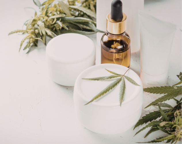 tubs and bottles of cbd balms and serums with hemp plants