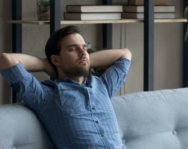 man relaxing on sofa