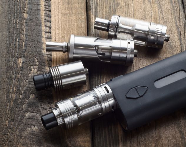 modern electric black vape pod on wooden surface