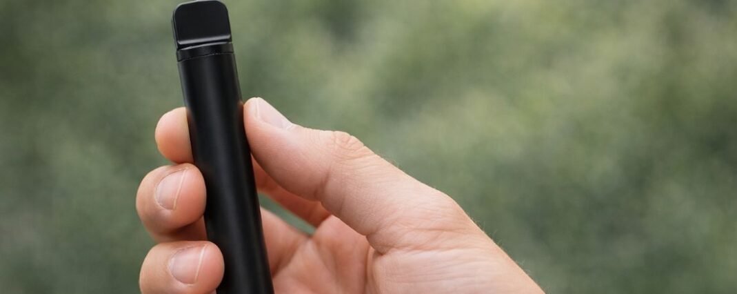 hand holding slim vape device