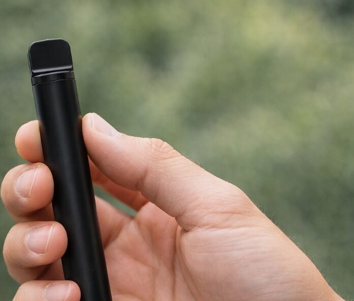 hand holding slim vape device