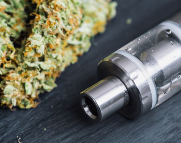 vape device next to cbd flower buds