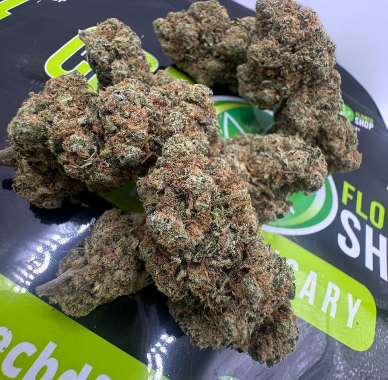 amnesia cbd flower buds on top of the cbd flower shop packaging